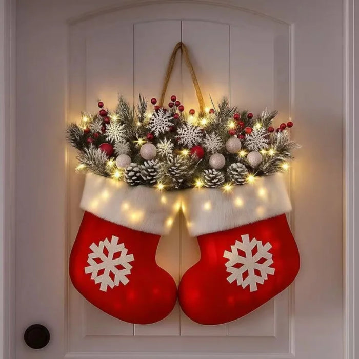 Julkrans vante med LED hängande på vägg