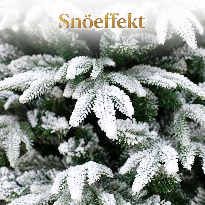 Snöpudrad konstgjord julgran med metallfot